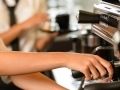 Close up hands waitress make coffee