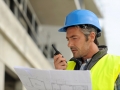 Portrait of construction manager using walkie-talkie